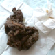A brunette woman takes a nice shit on a cloth-covered floor